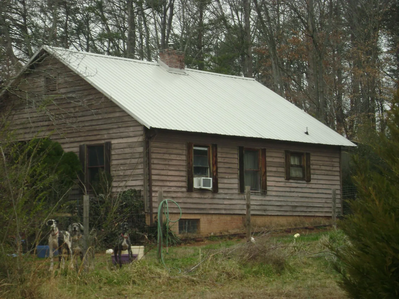 White metal roof on an old wood sided farmhouse, from a Metal Roof Installation job in Alamance